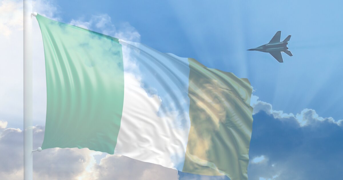 Image of an opague Irish flag to the left with a Russian warplane speeding towards it in sky filling up with clouds.