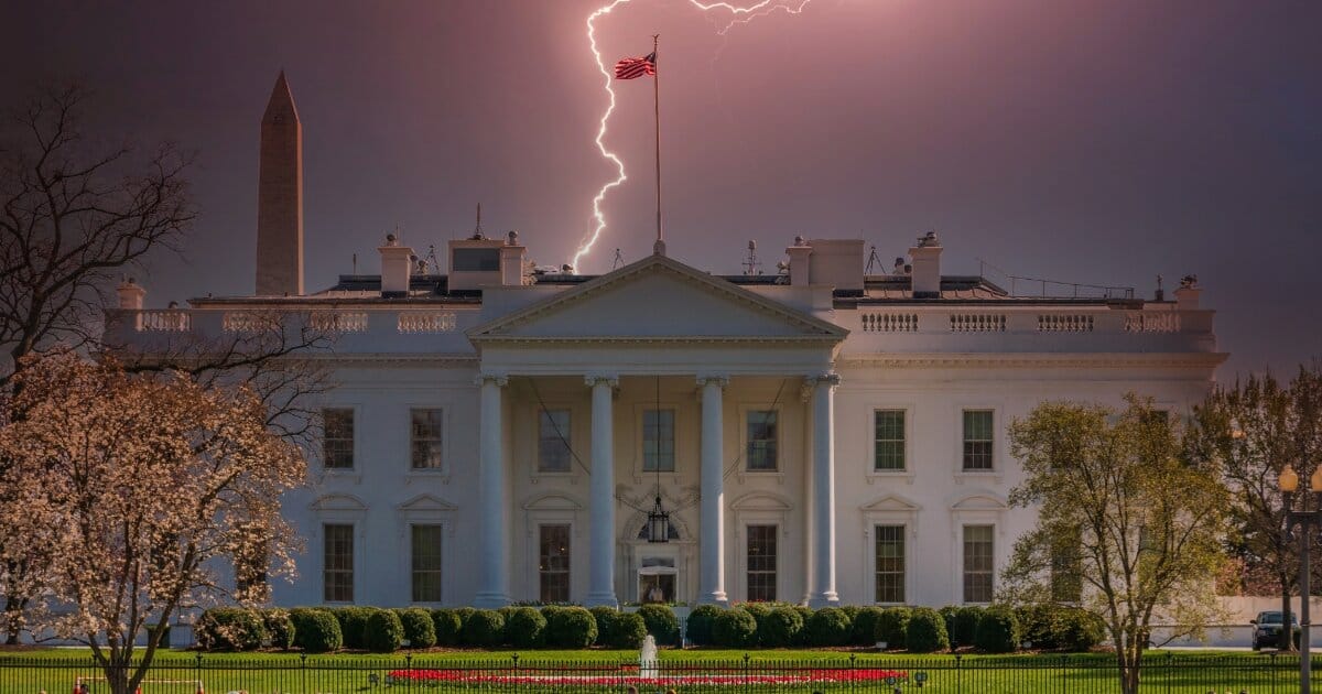 Image of the US White Hous in Washington DC, with clouds overhead that sheen red, and a fork of lightening striking down behind it in the distance.
